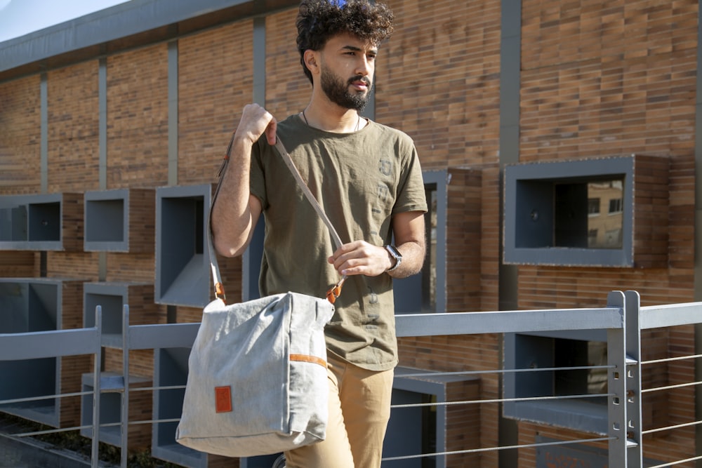 a man carrying a white bag on his shoulder