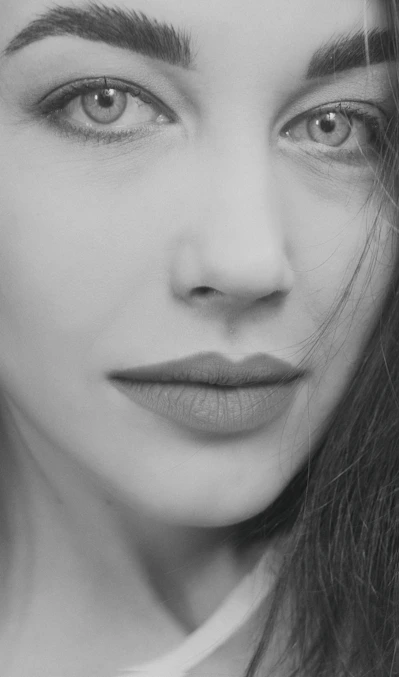 An intimate close-up portrait highlighting fine details and natural textures in soft, warm tones.