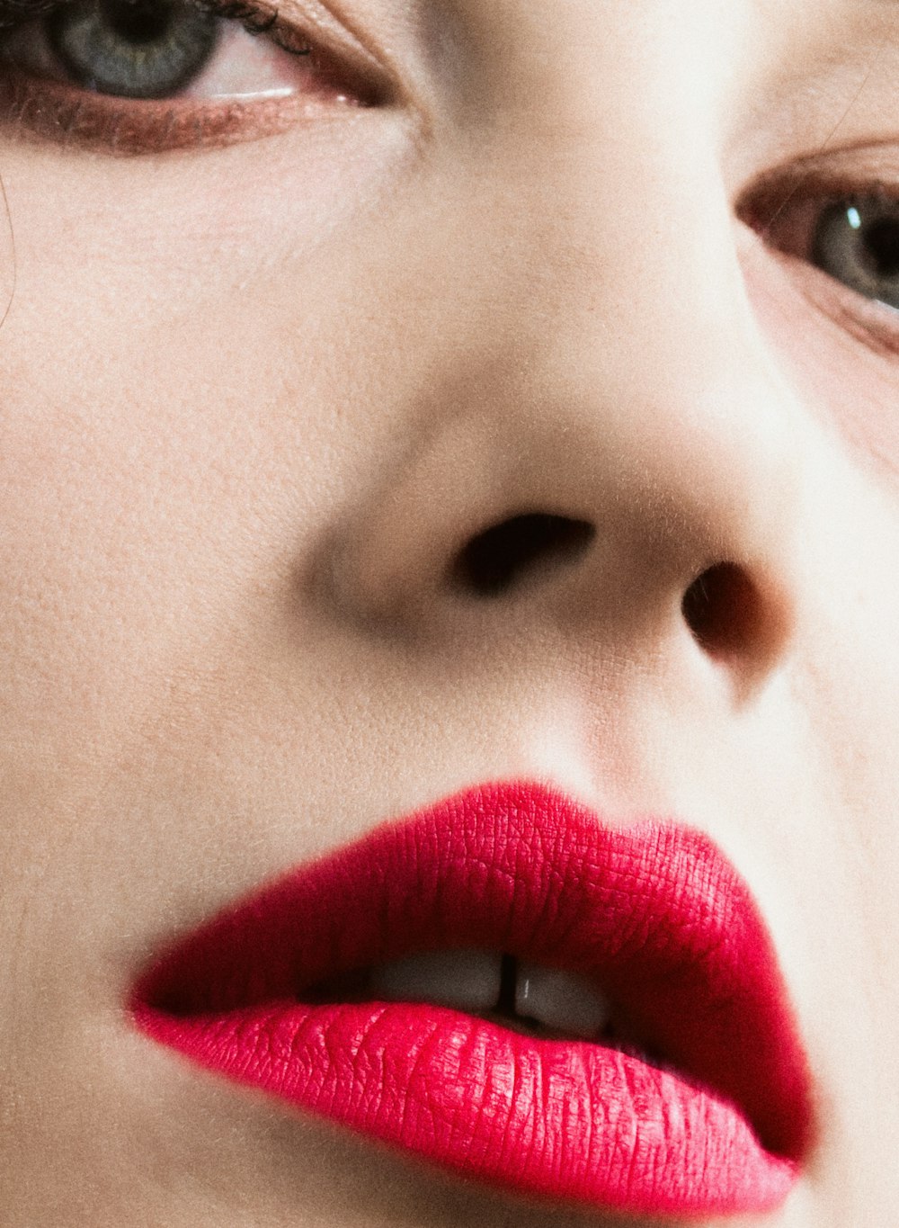 a close up of a woman with red lipstick