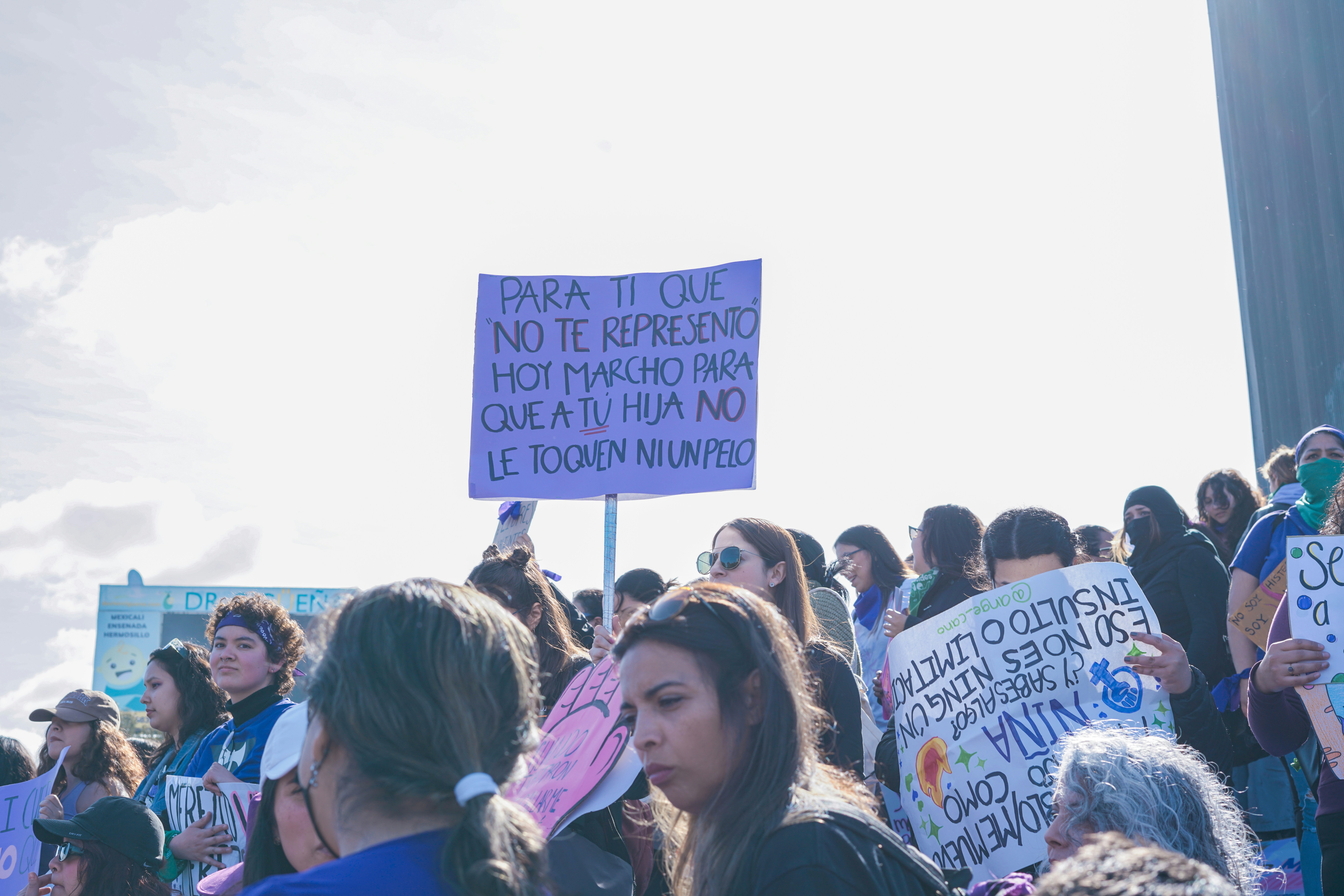 a group of people holding signs in a protest