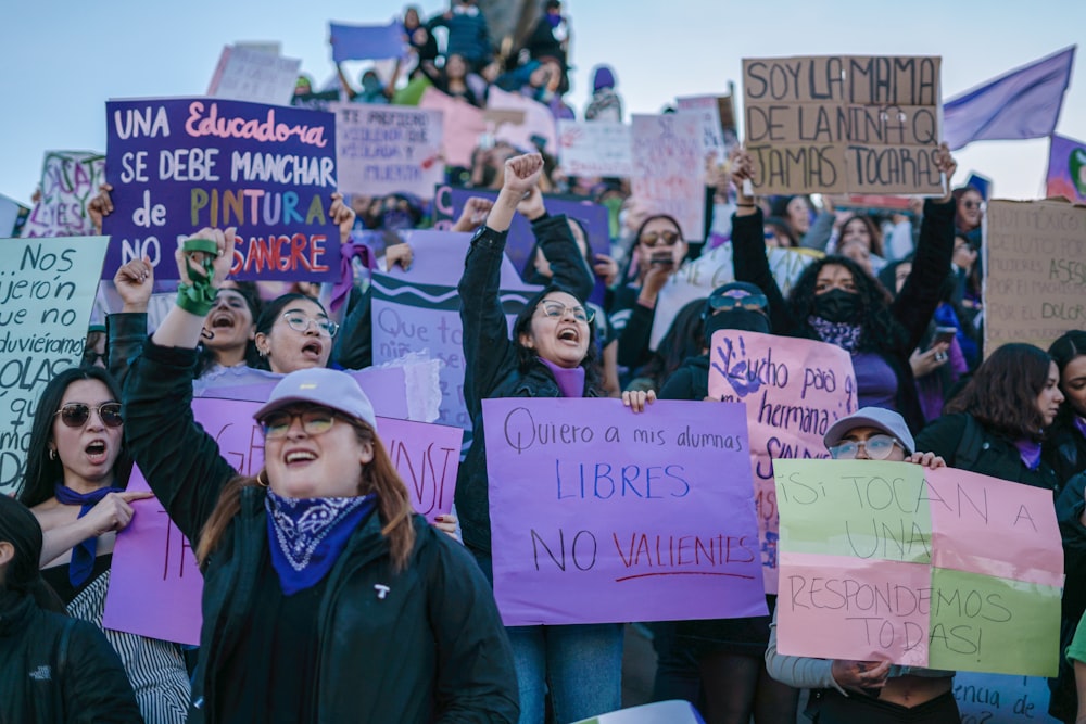 a group of people holding up signs in the air