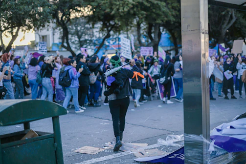Volunteers setting up a community awareness booth with purple banners in a local park.