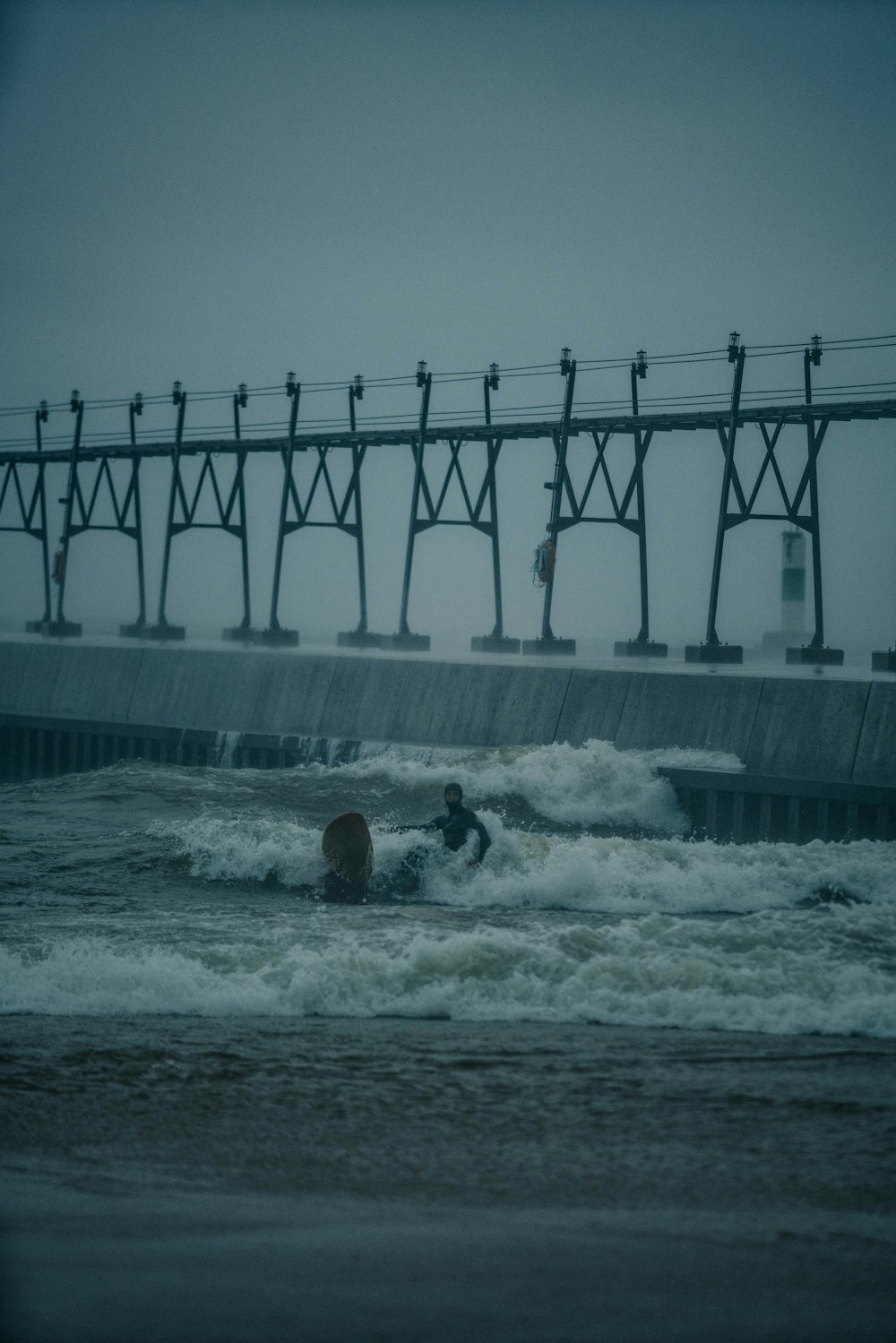 a man riding a surfboard on top of a wave in the ocean