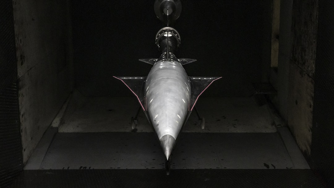 an airplane is shown in a dark room, Hermeus Quarterhorse wind tunnel model being tested for aerodynamics
