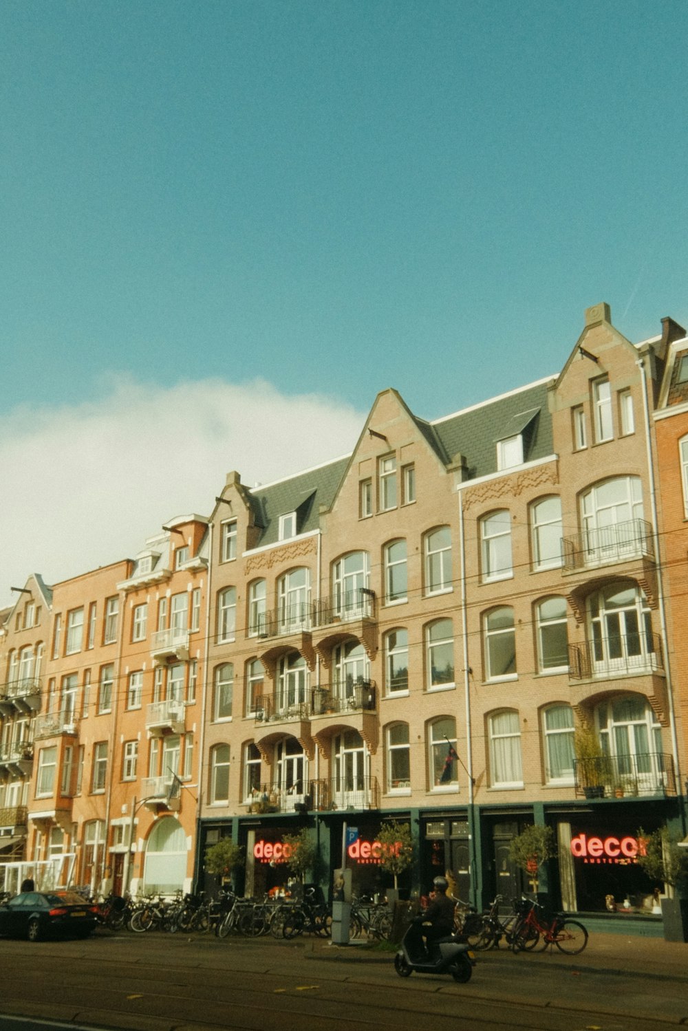 a row of buildings with bicycles parked in front of them