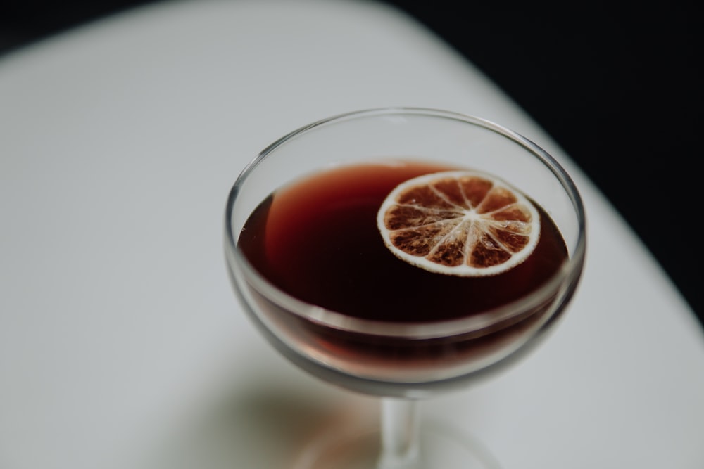 a close up of a wine glass with a drink in it