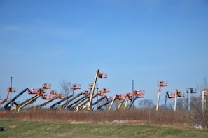 Wide shot of multiple rental machines lined up and ready for deployment on a bright day