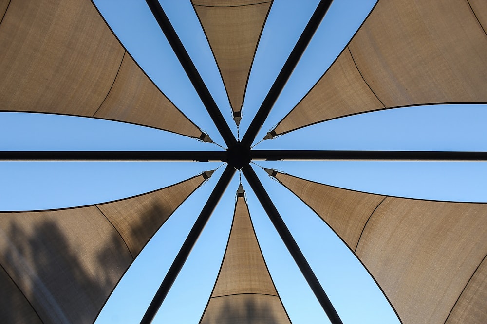 a close up of a large umbrella with a blue sky in the background