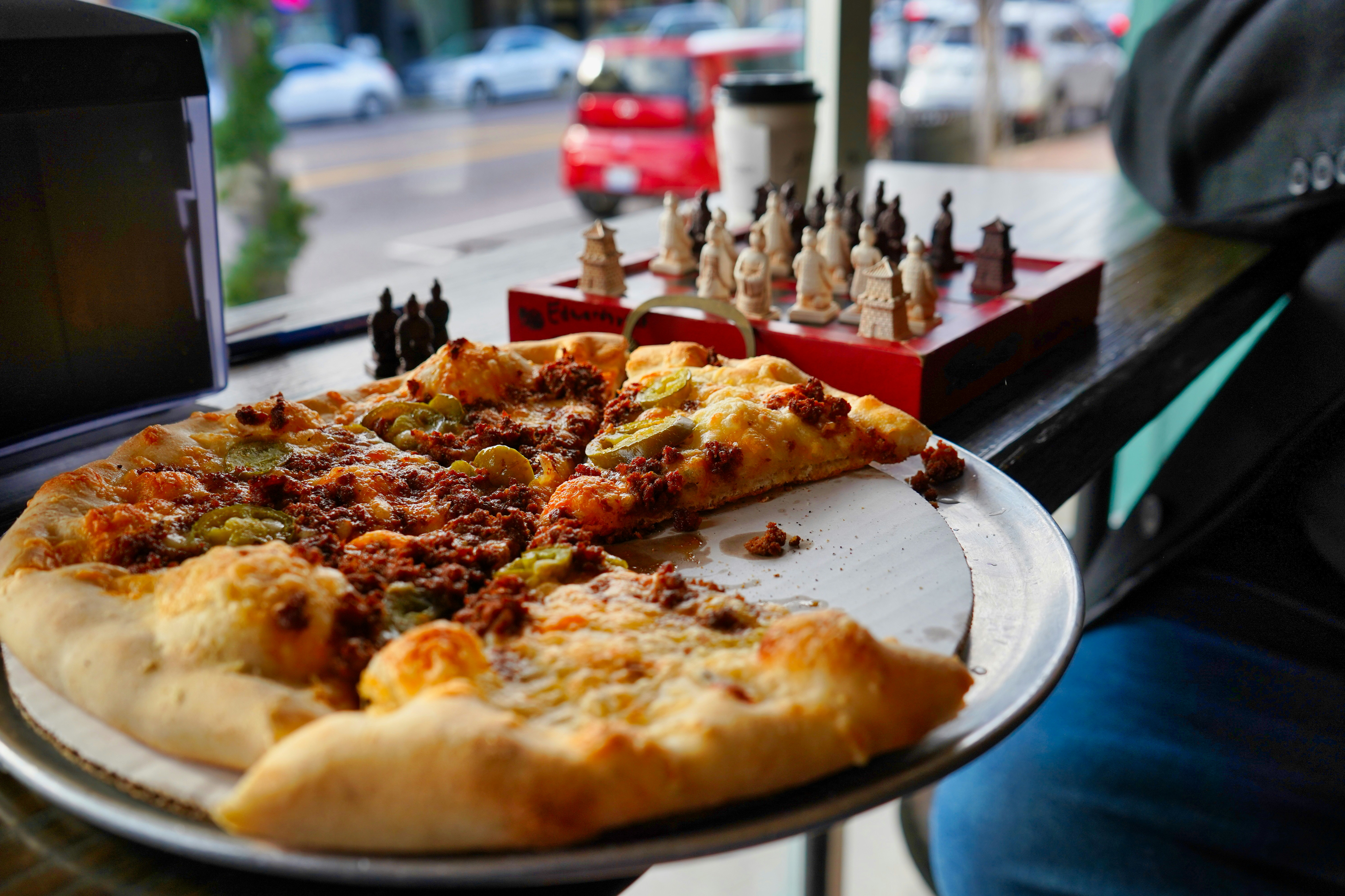 a pizza sitting on top of a pan on a table