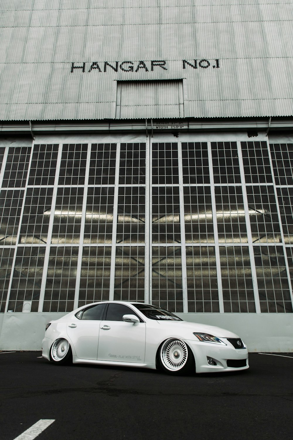 a white car parked in front of a building