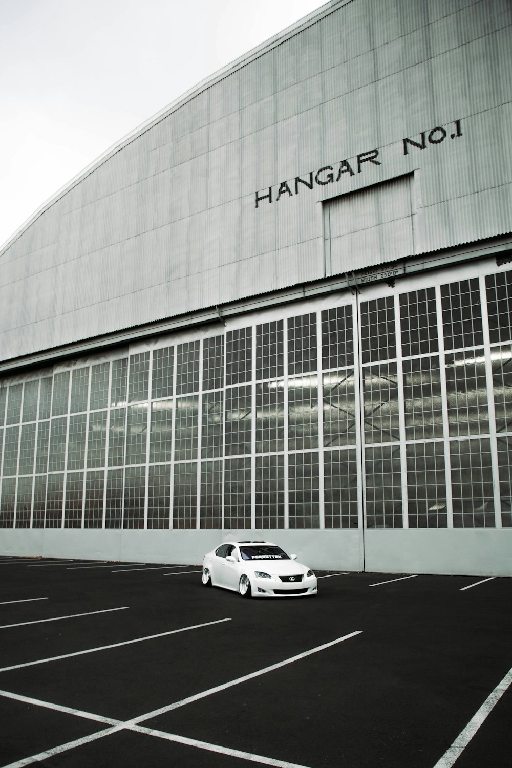 a white car parked in front of a building