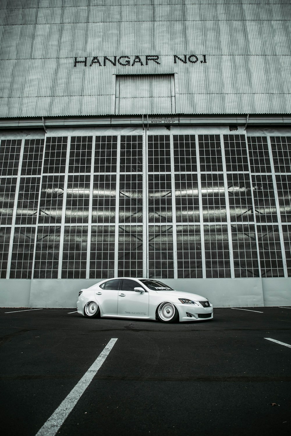 a white car parked in front of a building