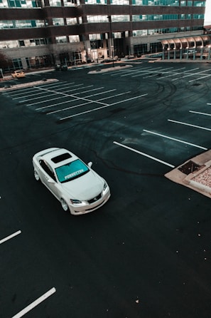a white car parked in a parking lot