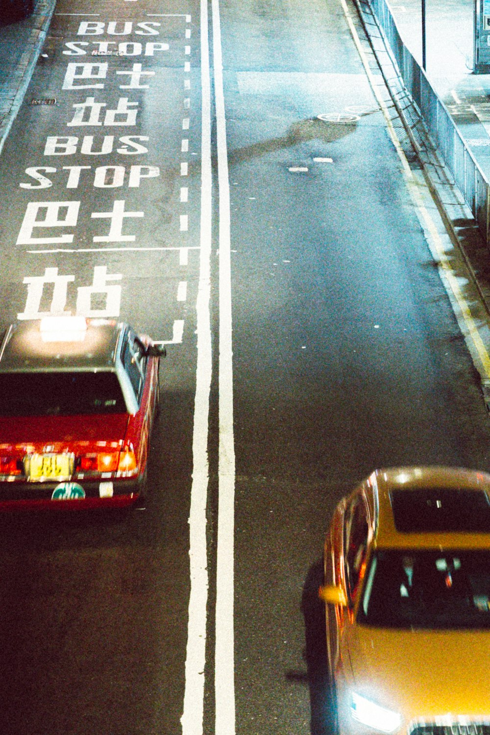 a couple of cars driving down a city street