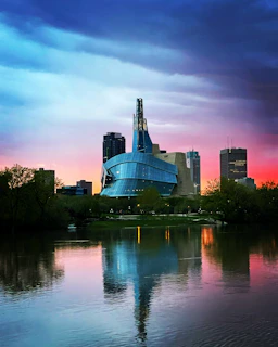 Finished architectural building with sleek design and landscaped surroundings at sunset.