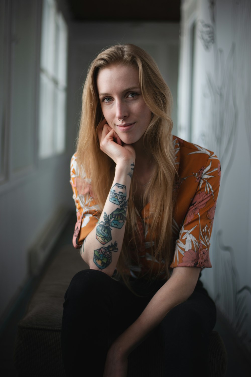 a woman with tattoos sitting on a bench