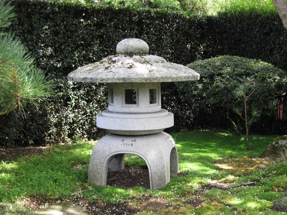 a stone lantern sitting in the middle of a garden