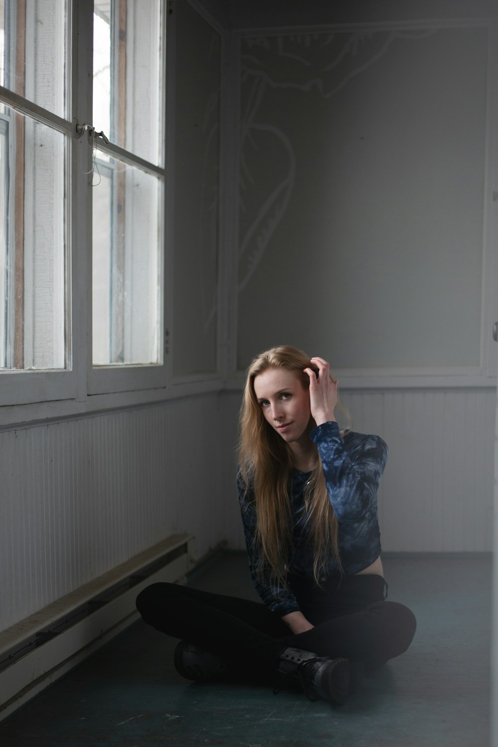 a woman sitting on the floor in a room