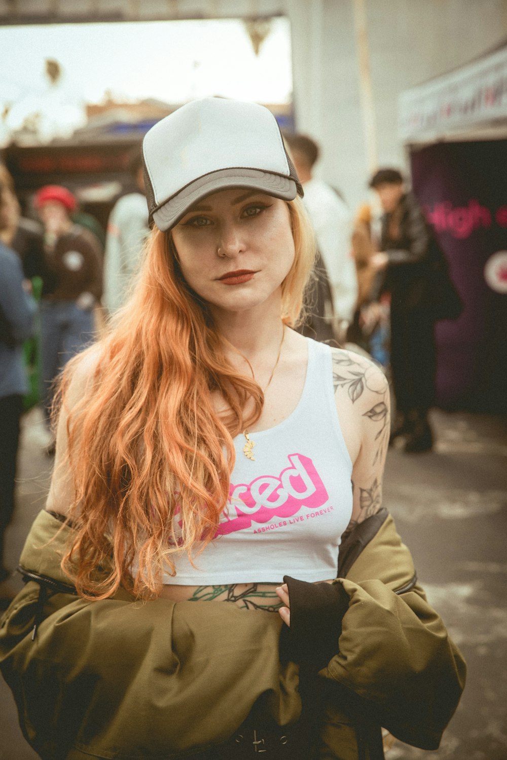 a woman with long red hair wearing a hat