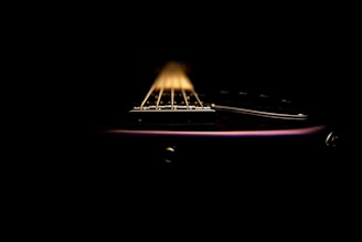 Close-up of guitar strings and drumsticks, emphasizing the instruments' textures