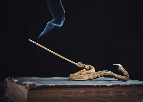 A mystical incense holder releasing fragrant smoke amidst a backdrop of spiritual books