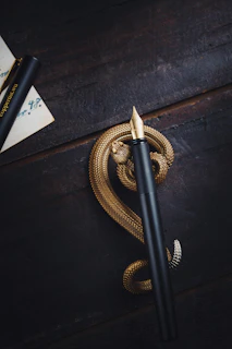A black fountain pen poised over a parchment page filled with dense philosophical writing.