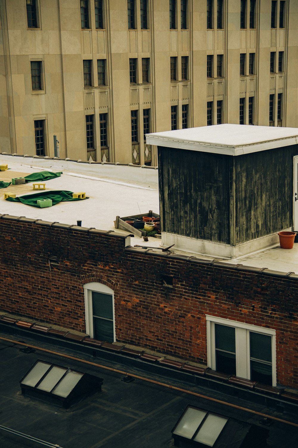 a rooftop with a building and a skylight in the background