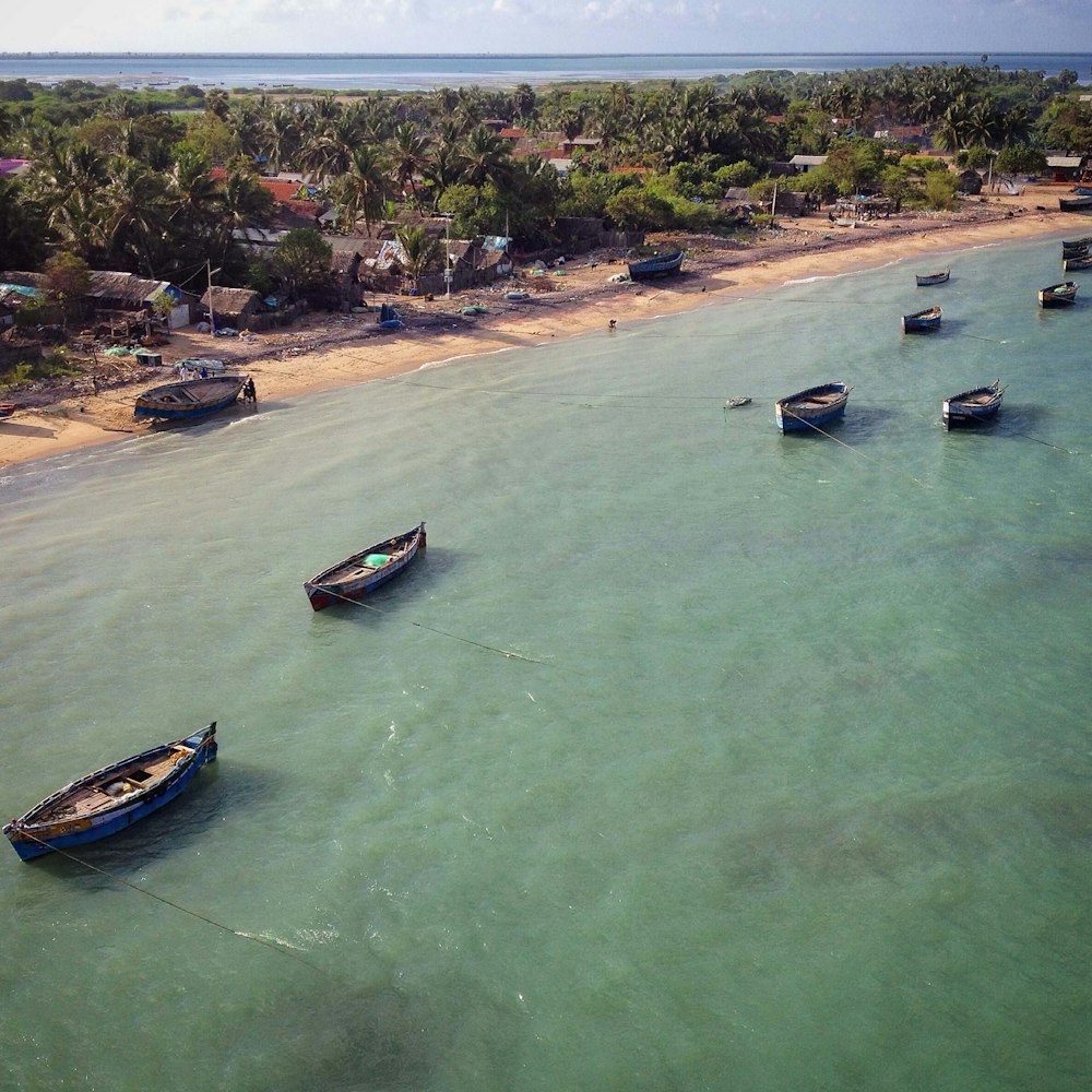 a group of boats floating on top of a body of water