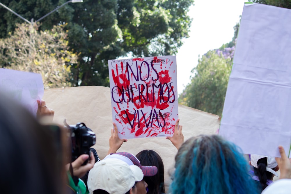 a group of people holding up a sign