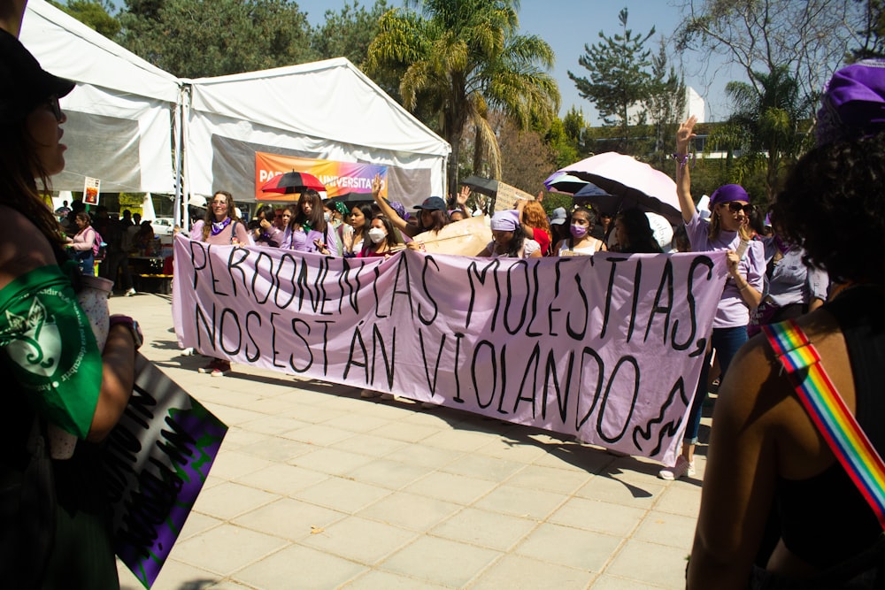 a group of people holding up a sign