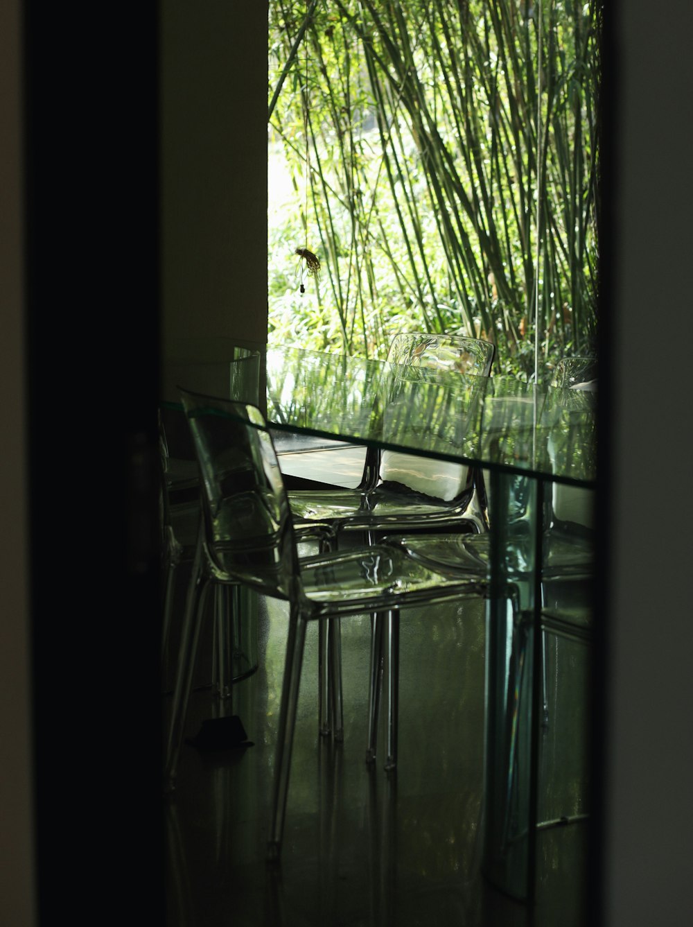 a glass table and chairs in a room