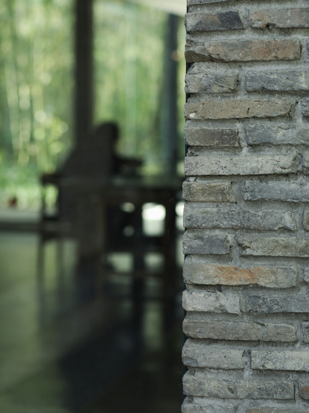 a brick wall with a bench in the background