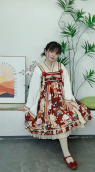 A playful cat modeling a bright, tailored dress in a cozy room
