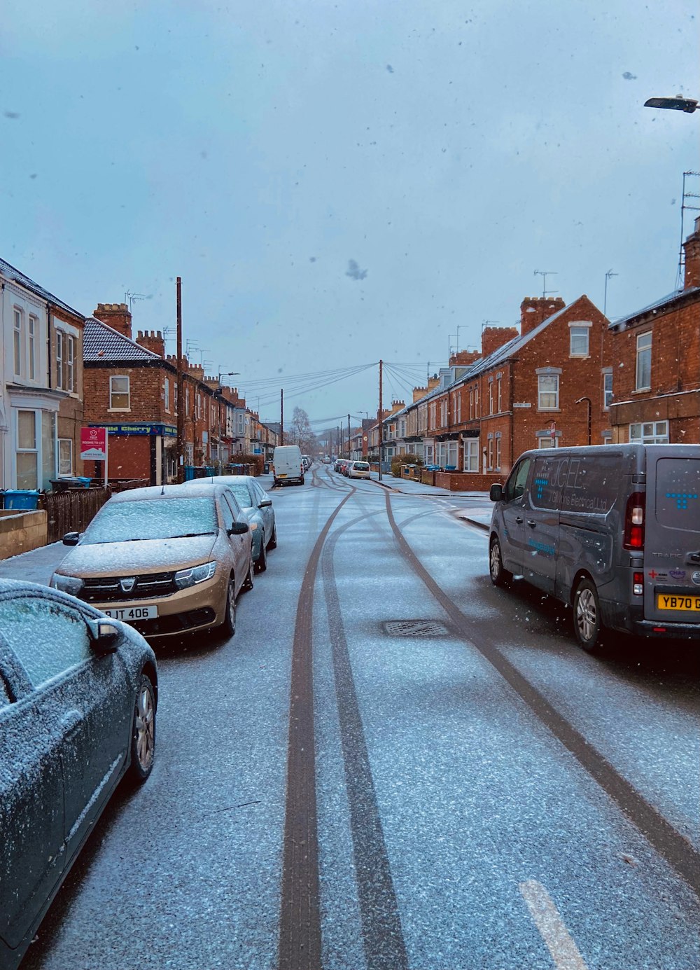 a street with cars parked on both sides of it