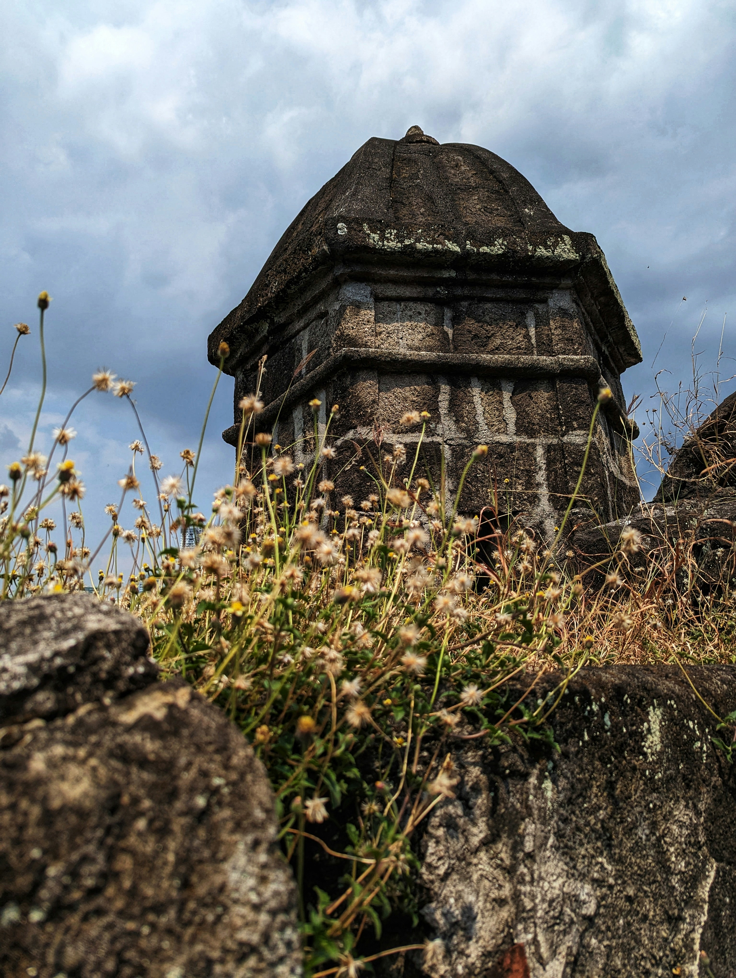 a stone tower with a clock on top of it