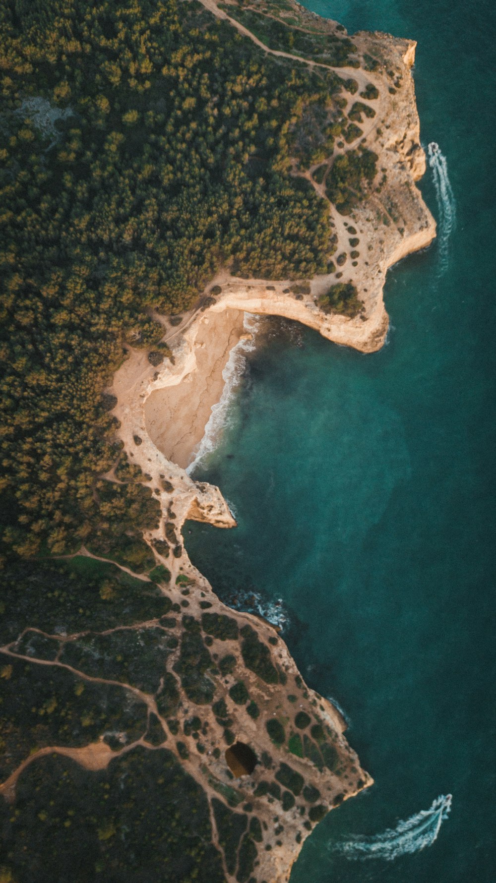 an aerial view of a body of water near a beach
