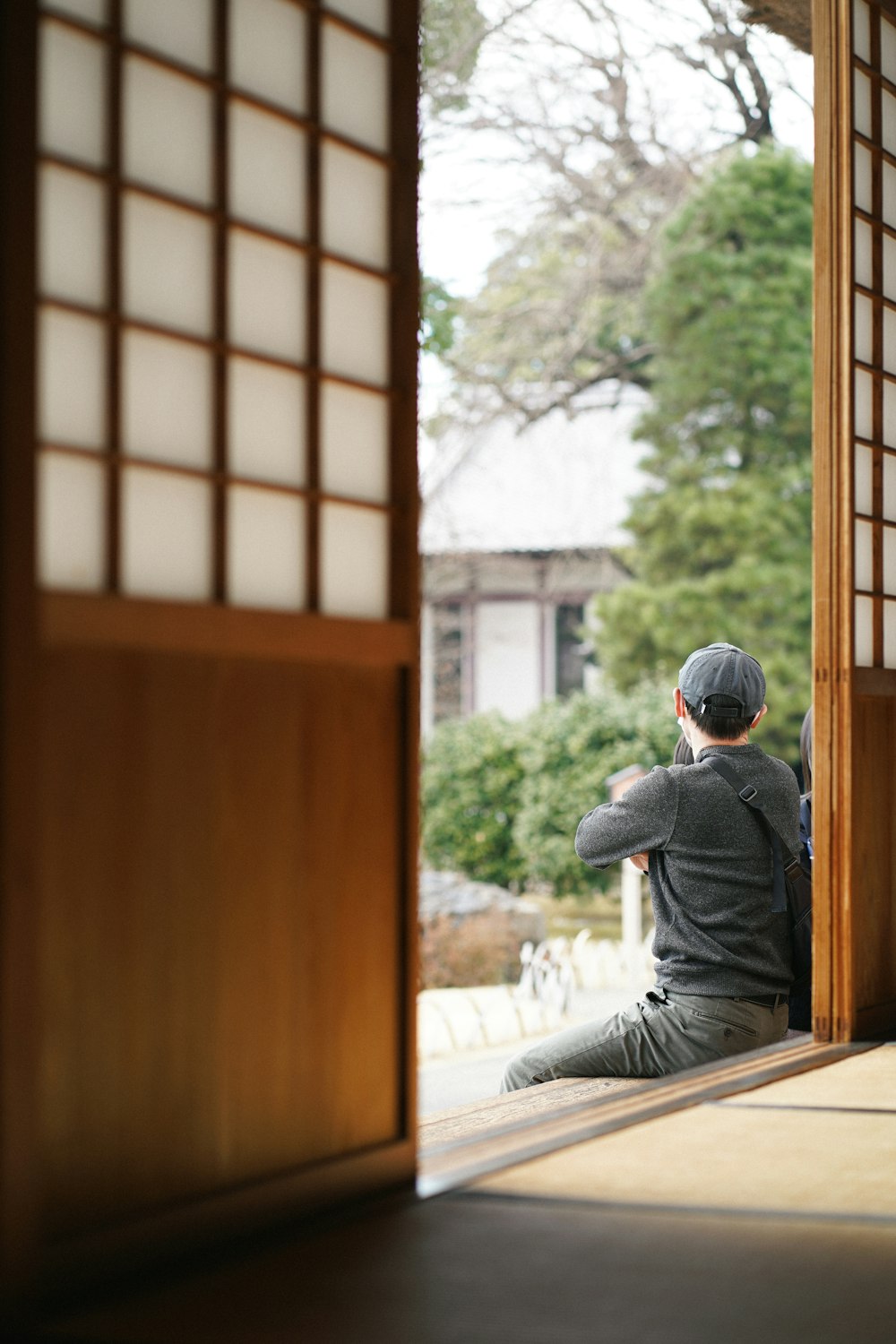 a man sitting on the floor in front of a doorway