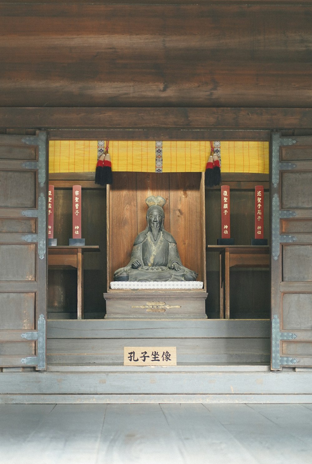 a statue of a monk in a shrine