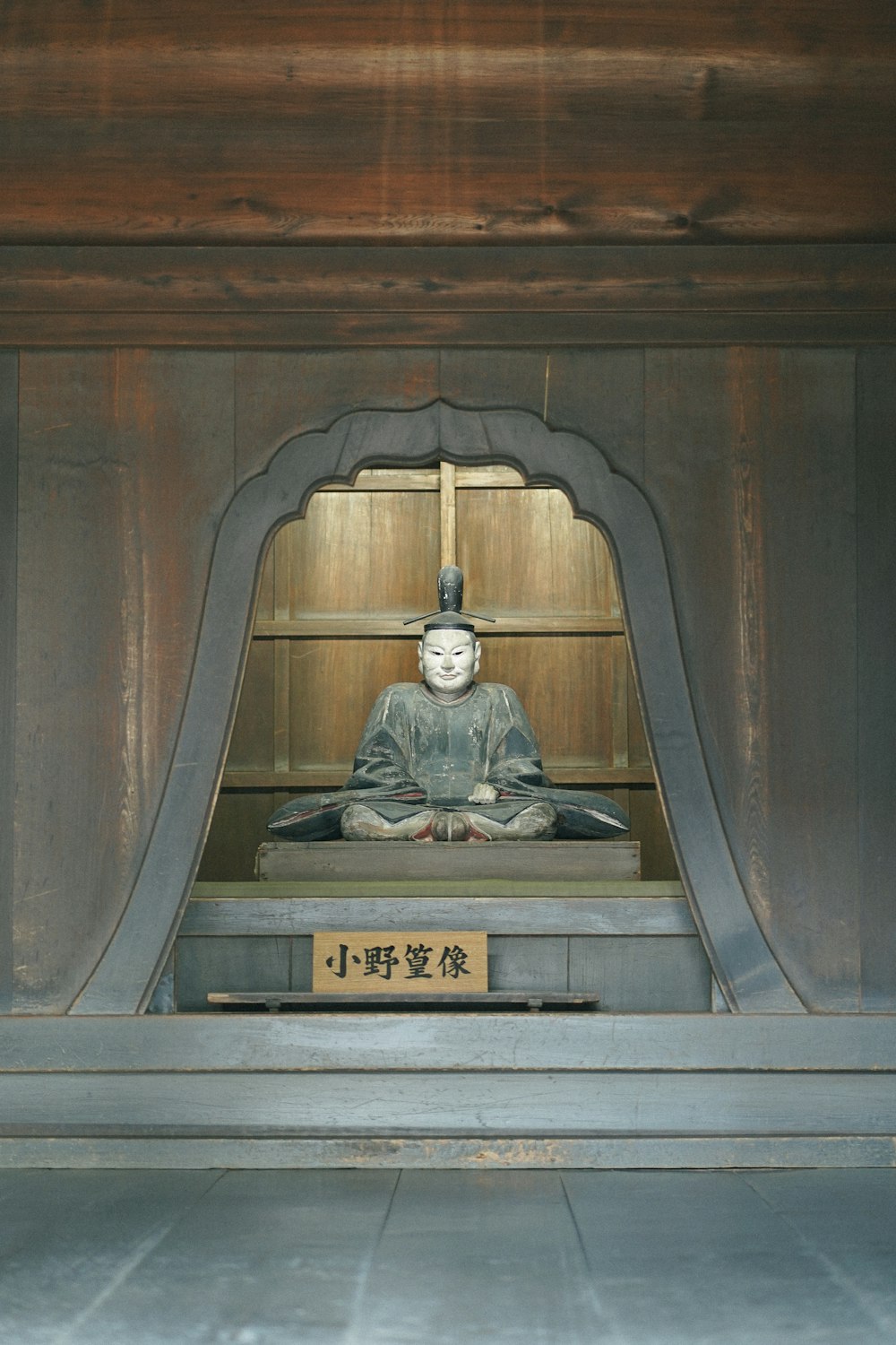 a statue of a person sitting in a shrine