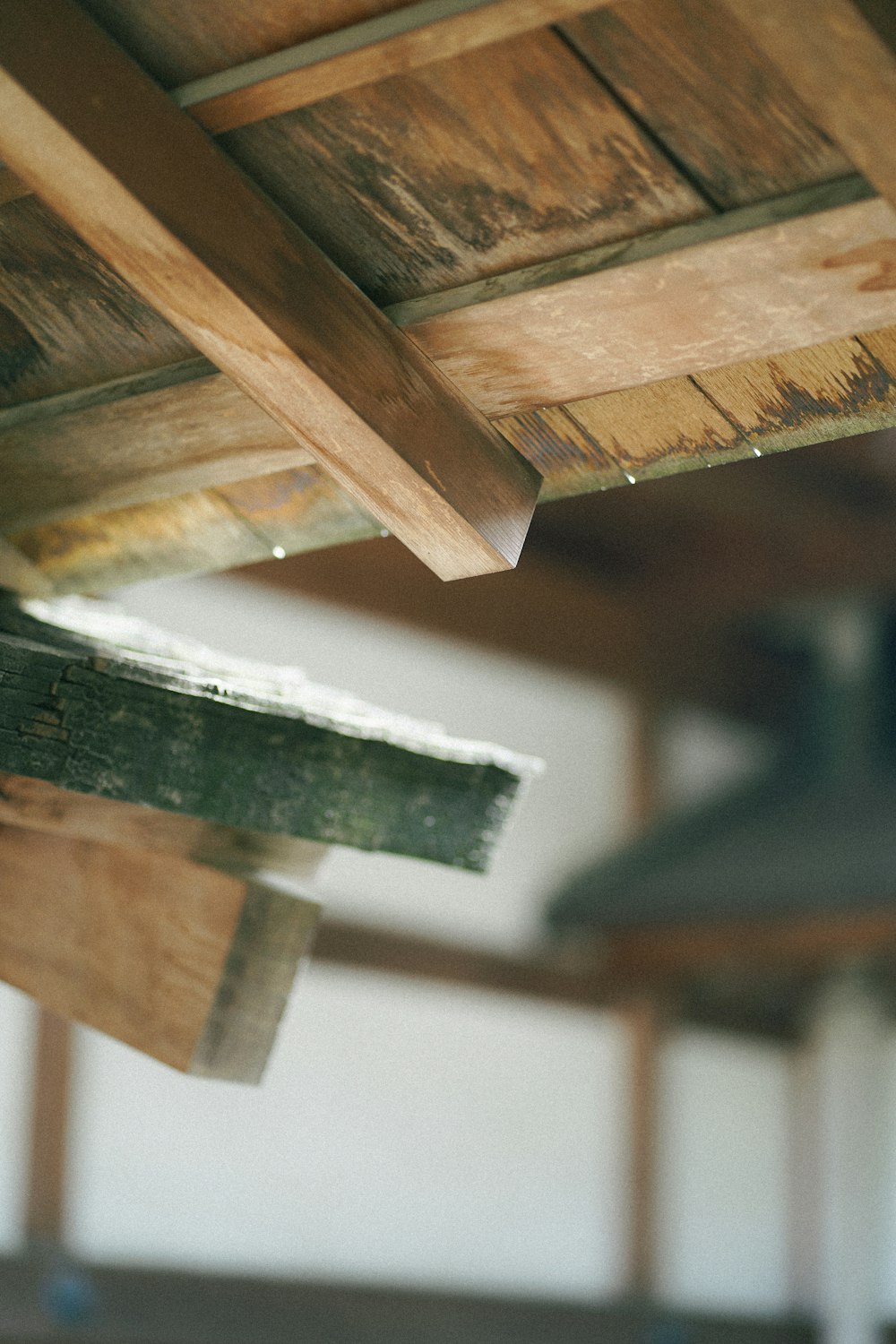 a close up of a wooden beam and a metal object
