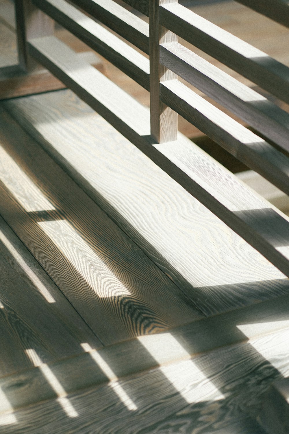 a wooden bench sitting on top of a hard wood floor