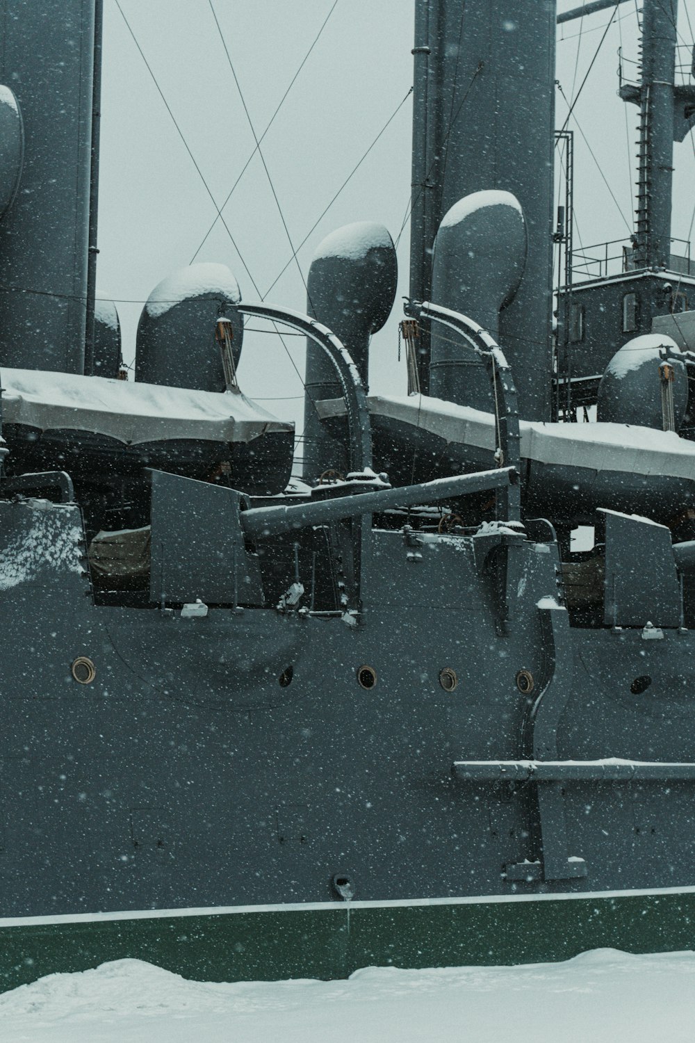 a large military ship is covered in snow