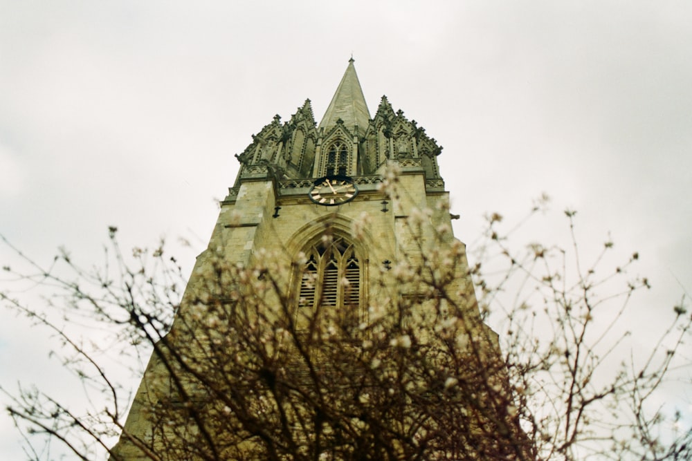 a very tall tower with a clock on it's side