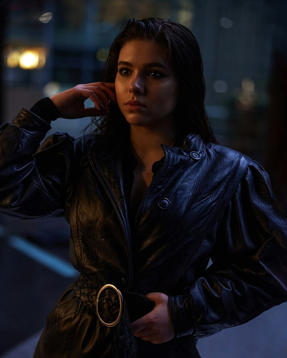 a woman in a black leather jacket posing for a picture