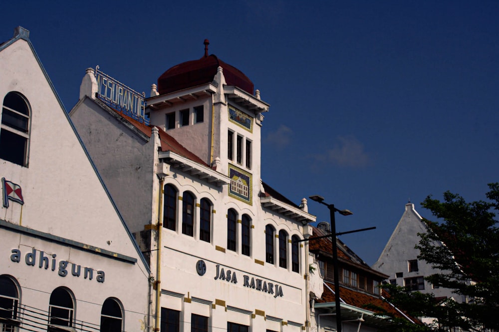 a large white building with a clock tower