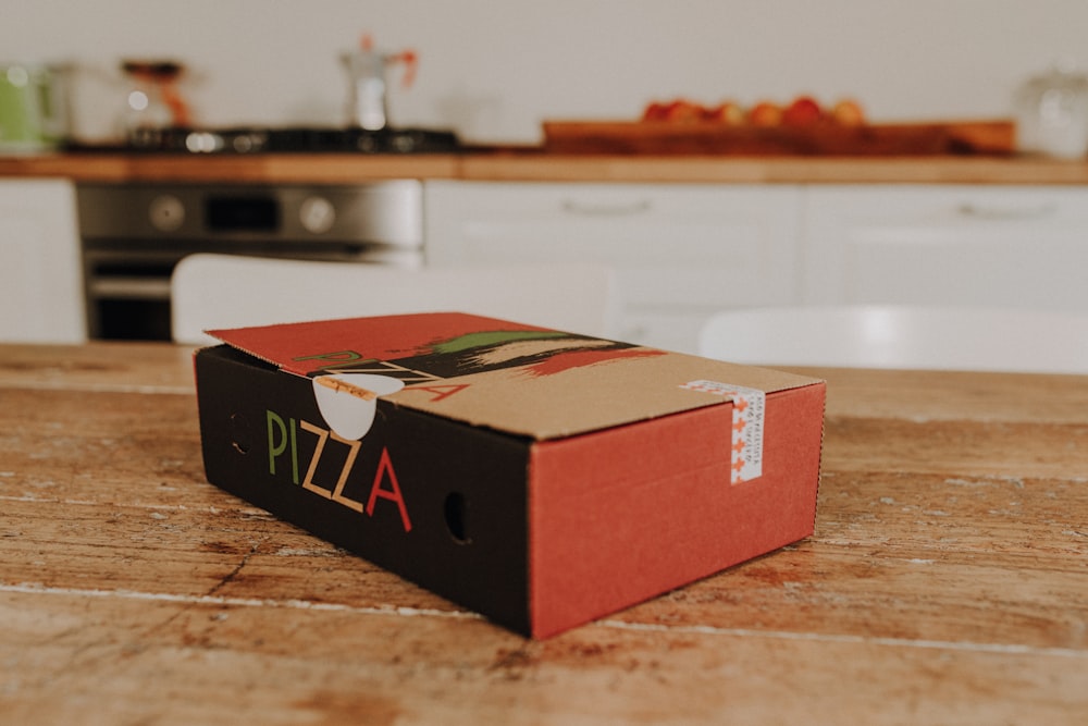 a pizza box sitting on top of a wooden table