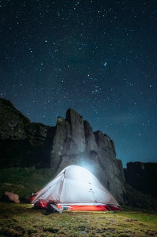 A vibrant tent revival gathering under a starlit sky.