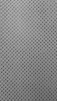 A close-up view of a textured fabric pattern featuring interlocking loops creating a mesh-like effect. The material appears to be knitted or woven with a consistent, repetitive design.