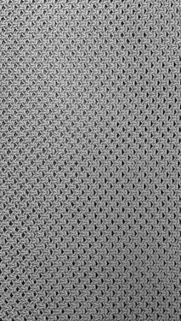 A close-up view of a textured fabric pattern featuring interlocking loops creating a mesh-like effect. The material appears to be knitted or woven with a consistent, repetitive design.