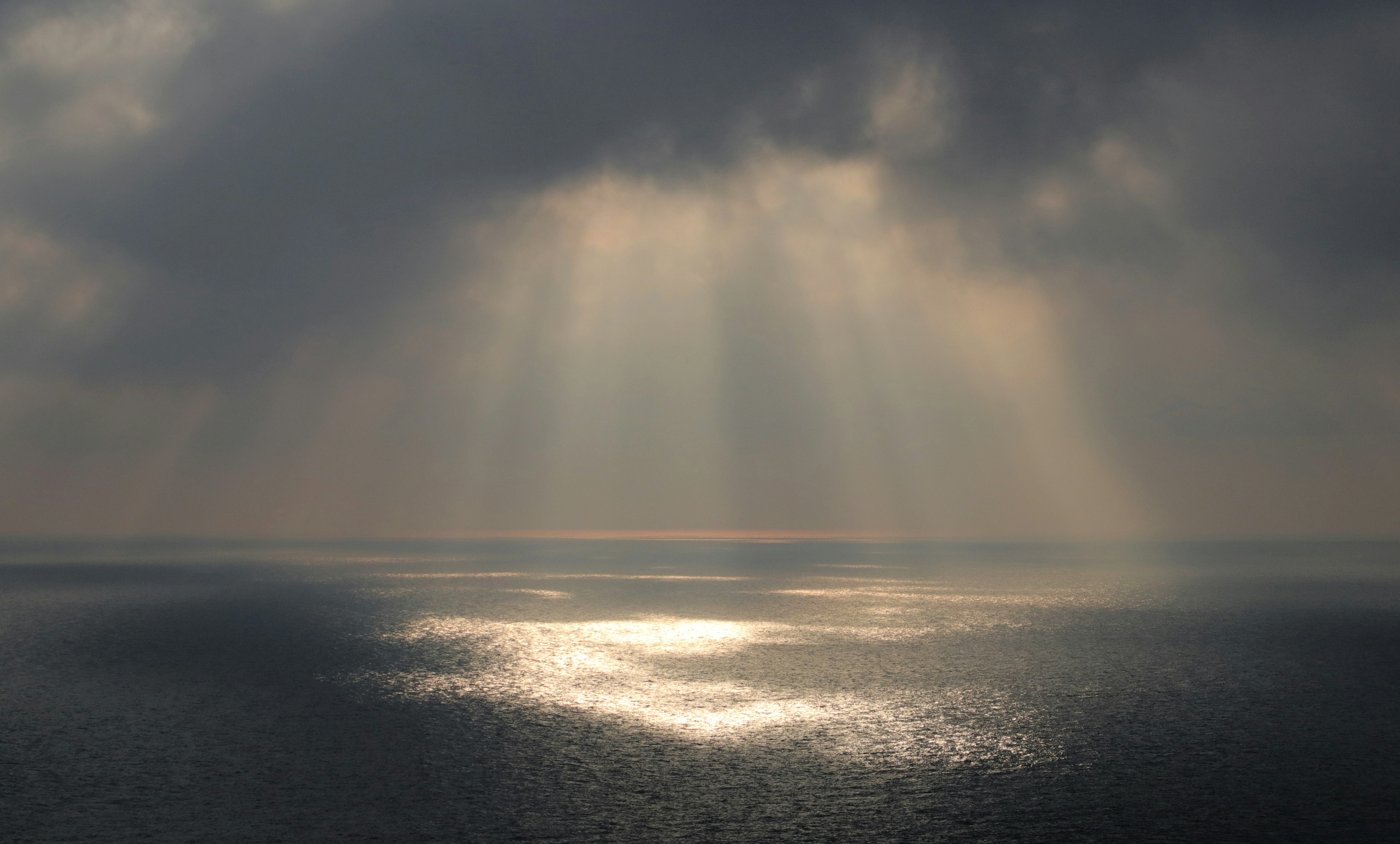 a large body of water under a cloudy sky
